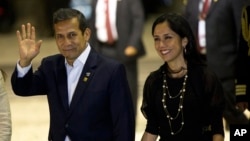 FILE - Peru's President Ollanta Humala waves to the press while arriving with his wife, Nadine Heredia, to the closing ceremony of a business summit in Paracas, Peru, July 2, 2015.