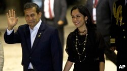 FILE - In this July 2, 2015, file photo, Peru's President Ollanta Humala waves to the press while arriving with his wife, Nadine Heredia, to the closing ceremony of a business summit in Paracas, Peru.