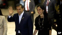 FILE - In this July 2, 2015, file photo, Peru's President Ollanta Humala waves to the press while arriving with his wife, Nadine Heredia, to the closing ceremony of a business summit in Paracas, Peru.