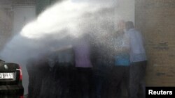 Turkish riot police use water cannon to disperse Kurdish demonstrators protesting against the removal of the local mayor from office over suspected links with Kurdish militants, in Diyarbakir, Turkey, Sept. 11, 2016. 