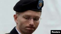 U.S. Army Private First Class Bradley Manning enters the courtroom for day four of his court martial at Fort Meade, Maryland, June 10, 2013. 