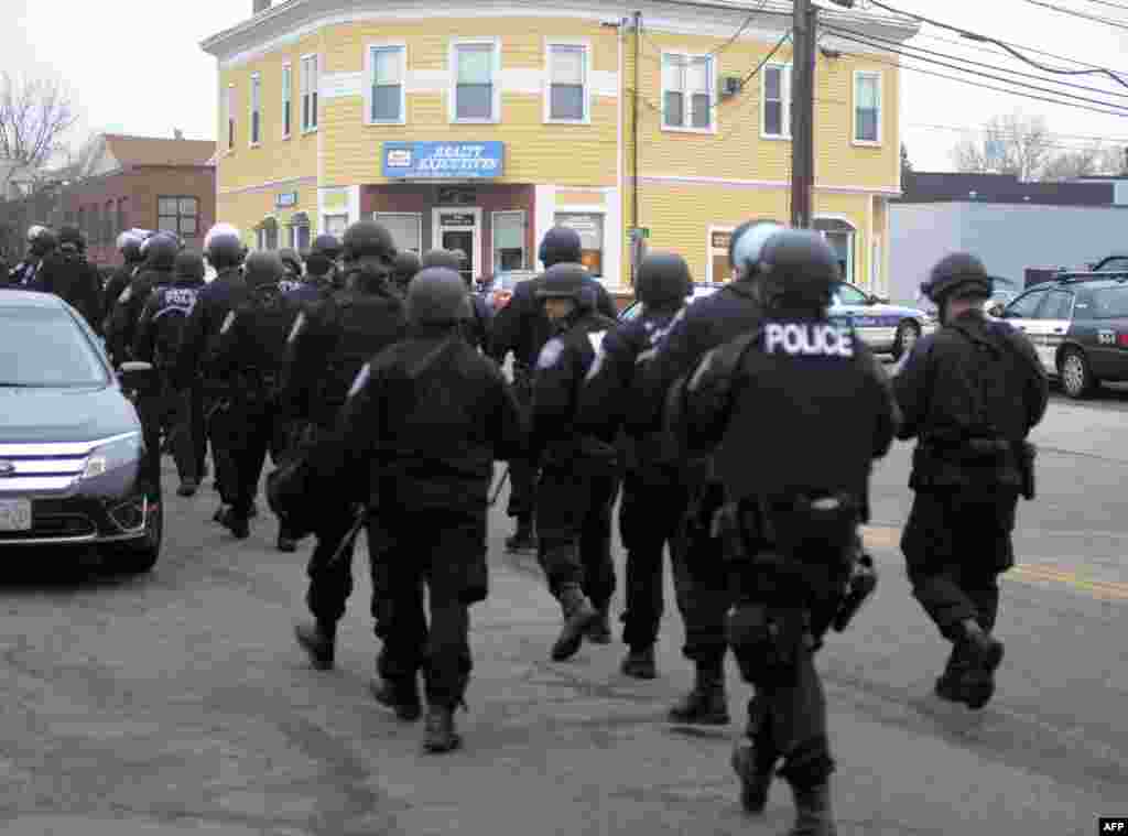 Police walk down School and Walnut Street on April 19, 2013 in Watertown, Massachusetts. 