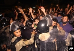 Iraqi riot police prevent protesters from storming the provincial council building during a demonstration in Basra, 550 kilometers (340 miles) southeast of Baghdad, Iraq, May 21, 2016.