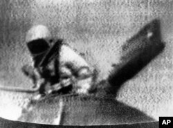 Soviet cosmonaut Alexey Leonov exits Soviet spacecraft Voskhod 2, becoming the first person to walk in space, in an Image from television. (AP Photo)