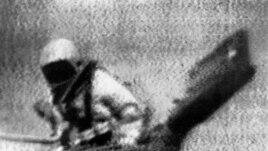 Soviet cosmonaut Alexey Leonov exits Soviet spacecraft Voskhod 2, becoming the first person to walk in space, in an Image from television. (AP Photo)