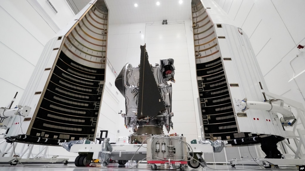 This Wednesday, Sept. 29, 2021 file photo shows NASA's Lucy spacecraft with its housing at the AstroTech facility in Titusville, Fla. It will be first space mission to explore a diverse population of small bodies known as the Jupiter Trojan asteroids. (AP Photo/John Raoux, File)