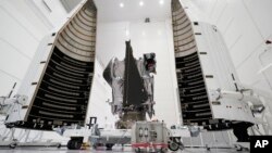 This Wednesday, Sept. 29, 2021 file photo shows NASA's Lucy spacecraft with its housing at the AstroTech facility in Titusville, Fla. It will be first space mission to explore a diverse population of small bodies known as the Jupiter Trojan asteroids. (AP Photo/John Raoux, File)