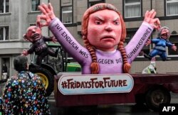 A carnival float joins protesters during a "Fridays for Future" school strike attended by Greta Thunberg prior to the traditional carnival parade in Duesseldorf, Germany, March 4, 2019.