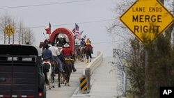 Members of the Valley Lodge Trail Ride make their way up a highway entrance ramp, in Houston to kick-off the Houston Livestock Show and Rodeo, (File February 24, 2011).