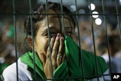 A fan of Brazil's Chapecoense soccer team cries during a tribute to the players who died in a plane crash in Colombia, at Arena Condado stadium in Chapeco, Brazil, Nov. 30, 2016.