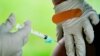 FILE - A health worker administers a dose of a COVID-19 vaccine during a vaccination clinic at the Reading Area Community College in Reading, Pennsylvania, Sept. 14, 2021. 