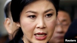 FILE - Thailand's Prime Minister Yingluck Shinawatra speaks to the media after a cabinet meeting at the Royal Thai Air Force Headquarters in Bangkok.