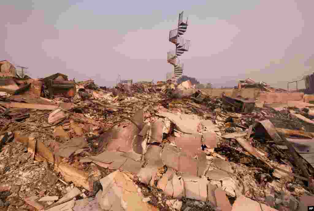 The charred remains of the burned out home are seen in Malibu, Calif., Nov. 10, 2018. Officials took advantage of temporarily calm conditions Saturday to assess damage from the blaze that's burned 109 square miles outside downtown Los Angeles. 