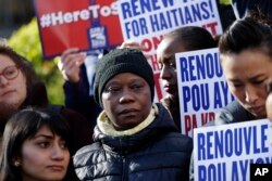 FILE - Immigration advocates protest the decision from the Department of Homeland Security to terminate Temporary Protected Status for people from Haiti, in New York, Nov. 21, 2017.