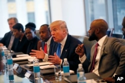 Republican presidential candidate Donald Trump holds a roundtable meeting with the Republican Leadership Initiative in his offices at Trump Tower in New York, Thursday, Aug. 25, 2016. Dr. Ben Carson is seated next to Trump at center.