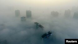 Buildings are seen on a hazy day in Xiangyang, Hubei province, China, Dec. 31, 2016. The current round of air pollution struck Friday and isn't expected to lift until Thursday.