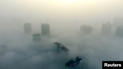 Buildings are seen on a hazy day in Xiangyang, Hubei province, China, Dec. 31, 2016. The current round of air pollution struck Friday and isn't expected to lift until Thursday.