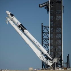 A SpaceX Falcon 9 rocket with the company's Crew Dragon spacecraft onboard is raised into vertical position on the launch pad at Launch Complex 39A as preparations continue for the Demo-2 mission, Thursday, May 21, 2020, at NASA's Kennedy Space Center.