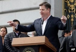 FILE - Acting San Francisco Mayor Mark Farrell speaks at a rally for clean energy in San Francisco, Feb. 28, 2018.