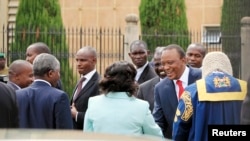 Kenyan President Uhuru Kenyatta (in red tie) arrives at the Parliament Building to deliver his state of the nation address in Nairobi, March 27, 2014.