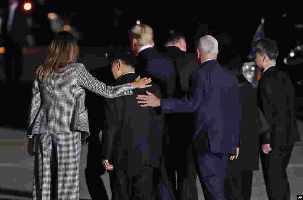 First lady Melania Trump and Vice President Mike Pence put their arms around North Korean detainee Tony Kim as they walk with President Donald Trump, Secretary of State Mike Pompeo, Kim Dong Chul, and Kim Hak Song as they leave Andrews Air Force Base, Md.