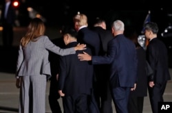 First lady Melania Trump and Vice President Mike Pence put their arms around North Korean detainee Tony Kim as they walk with President Donald Trump, Secretary of State Mike Pompeo, Kim Dong Chul, and Kim Hak Song as they leave Andrews Air Force Base, Md.