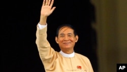 Win Myint, newly elected president of Myanmar, waves to media outside the parliament in Naypyitaw, Myanmar, in Naypyitaw, Myanmar, Wednesday, March 28, 2018.