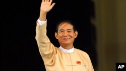 Win Myint, newly elected president of Myanmar, waves to media outside the parliament in Naypyitaw, Myanmar, in Naypyitaw, Myanmar, Wednesday, March 28, 2018.