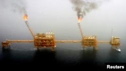 FILE - Gas flares from an oil production platform at the Soroush oil fields in the Persian Gulf, south of Tehran, July 25, 2005. 
