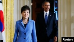 U.S. President Barack Obama and South Korea's President Park Geun-hye arrive for a joint news conference in the East Room of the White House in Washington, May 7, 2013. 