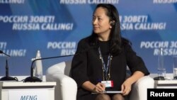 FILE - Huawei's Meng Wanzhou attends a session of the VTB Capital Investment Forum "Russia Calling!" in Moscow, Oct. 2, 2014. She was arrested last month in Vancouver at the request of the United States