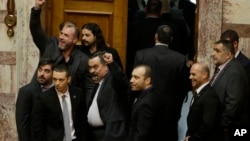 FILE - Lawmakers from the extreme right Golden Dawn party, shown outside parliament in Athens, and its leader will stand trial on criminal charges of participating in a criminal group, a judicial panel ruled Feb. 4, 2015.