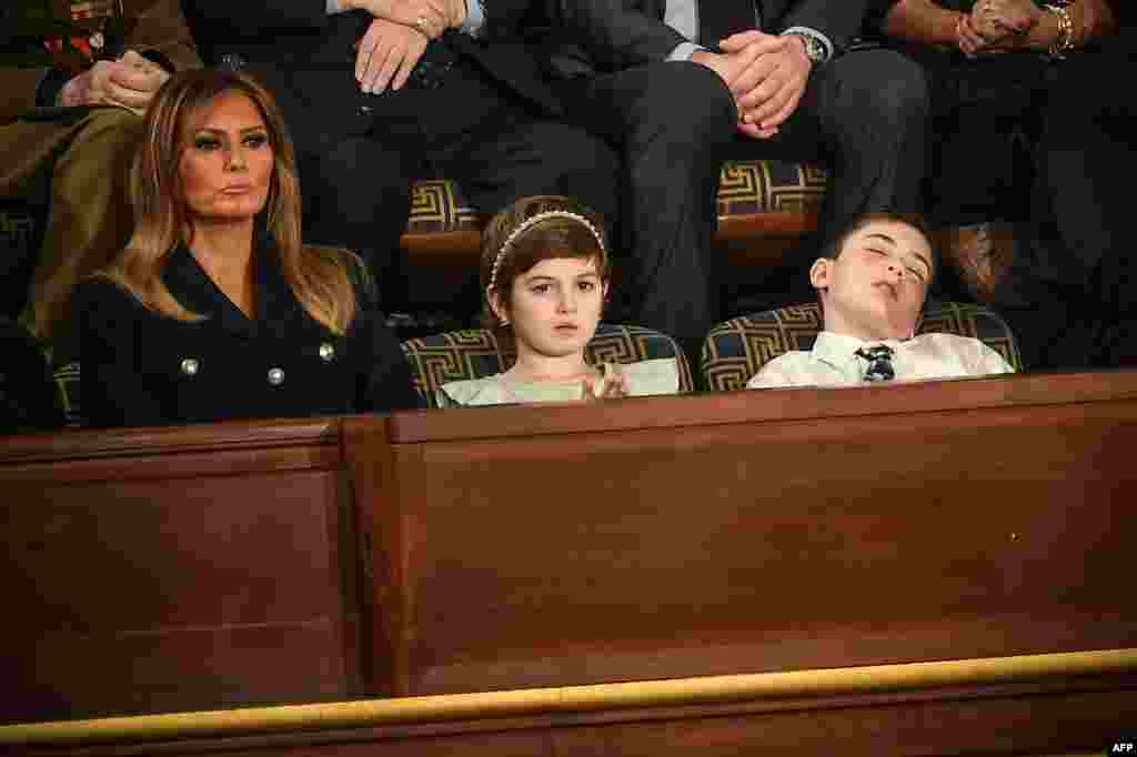 Special guest Joshua Trump falls asleep while U.S. first lady Melania Trump (L) and special guest Grace Eline listen to the State of the Union address at the U.S. Capitol in Washington, Feb. 5, 2019. Joshua is a sixth-grade student from Wilmington, Delaware, who has been bullied because of his last name.