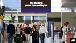 Passengers wear face masks as they arrive at the departures terminal at Sydney Domestic Airport in Sydney, Australia, Nov. 5, 2021. 