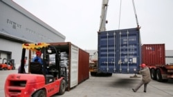 FILE: Men work on unloading the rubber imported from Belt and Road Initiative (BRI) countries at a bonded logistics centre in Nantong, Jiangsu province, China, May 17, 2019.