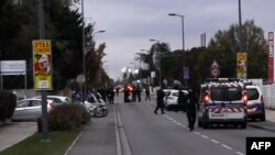 An image grab from an AFP TV video shows police vehicles in a street where a man rammed his car into a group of people in Blagnac, near the southern French city of Toulouse, Nov. 10, 2017, injuring one of them seriously, said justice officials, who indicated the attack was not linked to terrorism.