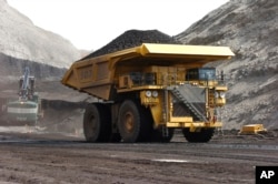 FILE - A mining truck hauls coal at Cloud Peak Energy's Spring Creek strip mine near Decker, Mont. The Northern Cheyenne Tribe challenged the Trump administration decision to life a moratorium on coal leases.