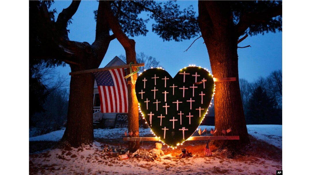 FILE - A makeshift memorial with crosses for the victims of the Sandy Hook Elementary School shooting massacre stands outside a home in Newtown, Conn., on the one-year anniversary of the shootings, Dec. 14, 2013.