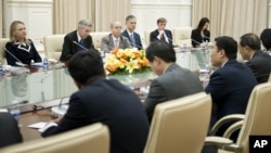 U.S. Secretary of State Hillary Rodham Clinton, left, listens to Chinese Foreign Minister Yang Jiechi, right, during their meeting at the Peace Palace in Phnom Penh, Cambodia, July 12, 2012.