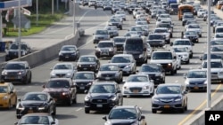 In this Aug. 1, 2018, photo, cars on the Grand Central Parkway pass LaGuardia Airport in New York. (AP Photo/Frank Franklin II)