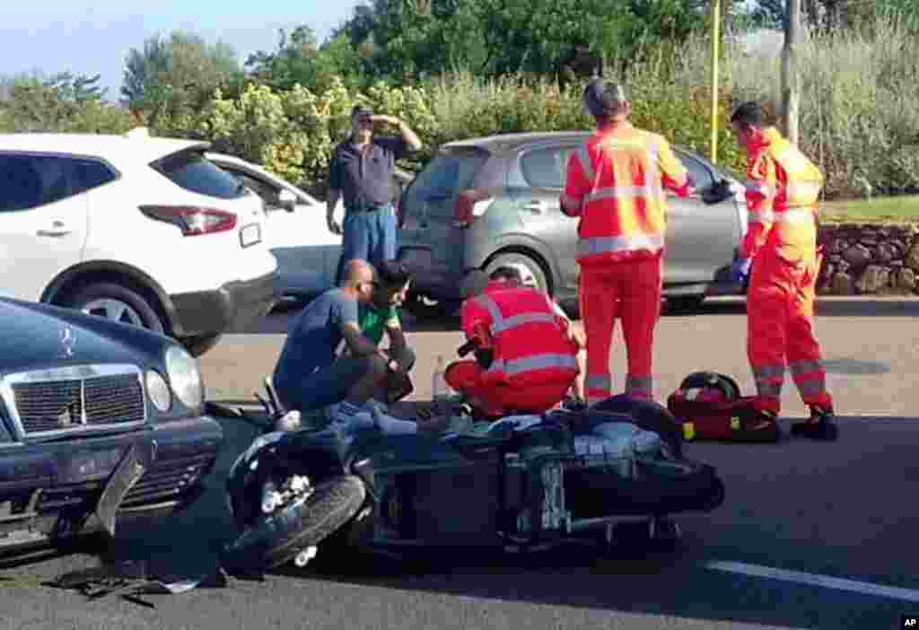 Ambulance personnel tend to a man lying on the ground, later identified as actor George Clooney, after he was involved in a motor scooter accident near Olbia, on Sardinia island, Italy. Clooney was taken to the hospital in Sardinia and released, hospital officials said. &ldquo;He is recovering at his home and will be fine,&rdquo; spokesman Stan Rosenfield told The Associated Press in an email.