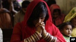 Pakistani Christians attend a prayer service on the first day of the New Year at a local church in Lahore, Pakistan, Wednesday, Jan. 1, 2014. (AP Photo/K.M. Chaudary)