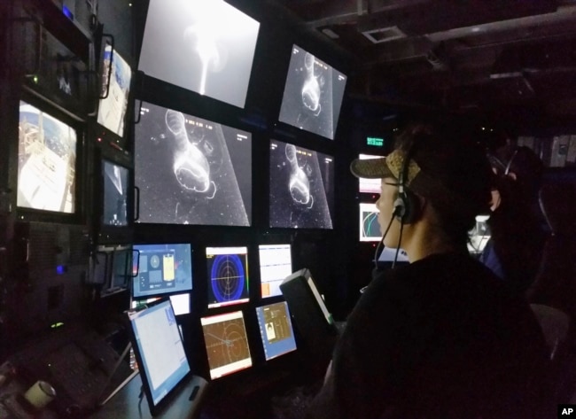 In this 2015 photo provided by the Monterrey Bay Aquarium Research Institute, Kakani Katija works in the remote operated vehicle control room on MBARI’s research vessel Western Flyer as the DeepPIV system illuminates a giant larvacean. (Kim Reisenbichler/MBARI via AP)