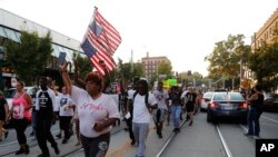 FILE - Demonstrators march in response to a not guilty verdict in the trial of former St. Louis police officer Jason Stockley in St. Louis, Sept. 16, 2017.