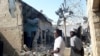 FILE - People gather at the scene of an explosion in Maiduguri, Nigeria, Dec. 23, 2021.