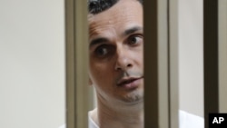 Oleh Sentsov stands behind glass in a cage at a courtroom in Rostov-on-Don, Russia, July 21, 2015.