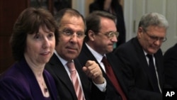 FILE - In this Monday, July 11, 2011 file photo from left : European Union High Representative Catherine Ashton, Russian Foreign Minister Sergey Lavrov, Russian Deputy Foreign Minister Mikhail Bogdanov and Russian Ambassador Sergei Yakovlev, attend a dinner at the State Department in Washington. 