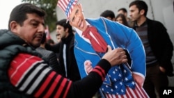 Plainclothes police officers in Turkey take away an effigy of President Barack Obama as members of Turkey Youth Union gather to protest the upcoming visit of Obama to Turkey for the G20 Summit in Antalya (AP Photo/Emrah Gurel). 