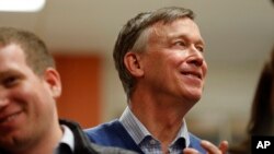 FILE - Former Colorado Gov. John Hickenlooper waits to speak at the Story County Democrats' annual soup supper fundraiser, Feb. 23, 2019, in Ames, Iowa.
