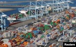 FILE - Shipping containers sit at the ports of Los Angeles and Long Beach, Calif., in this aerial photo, Feb. 6, 2015. China is the largest trading partner for both ports.